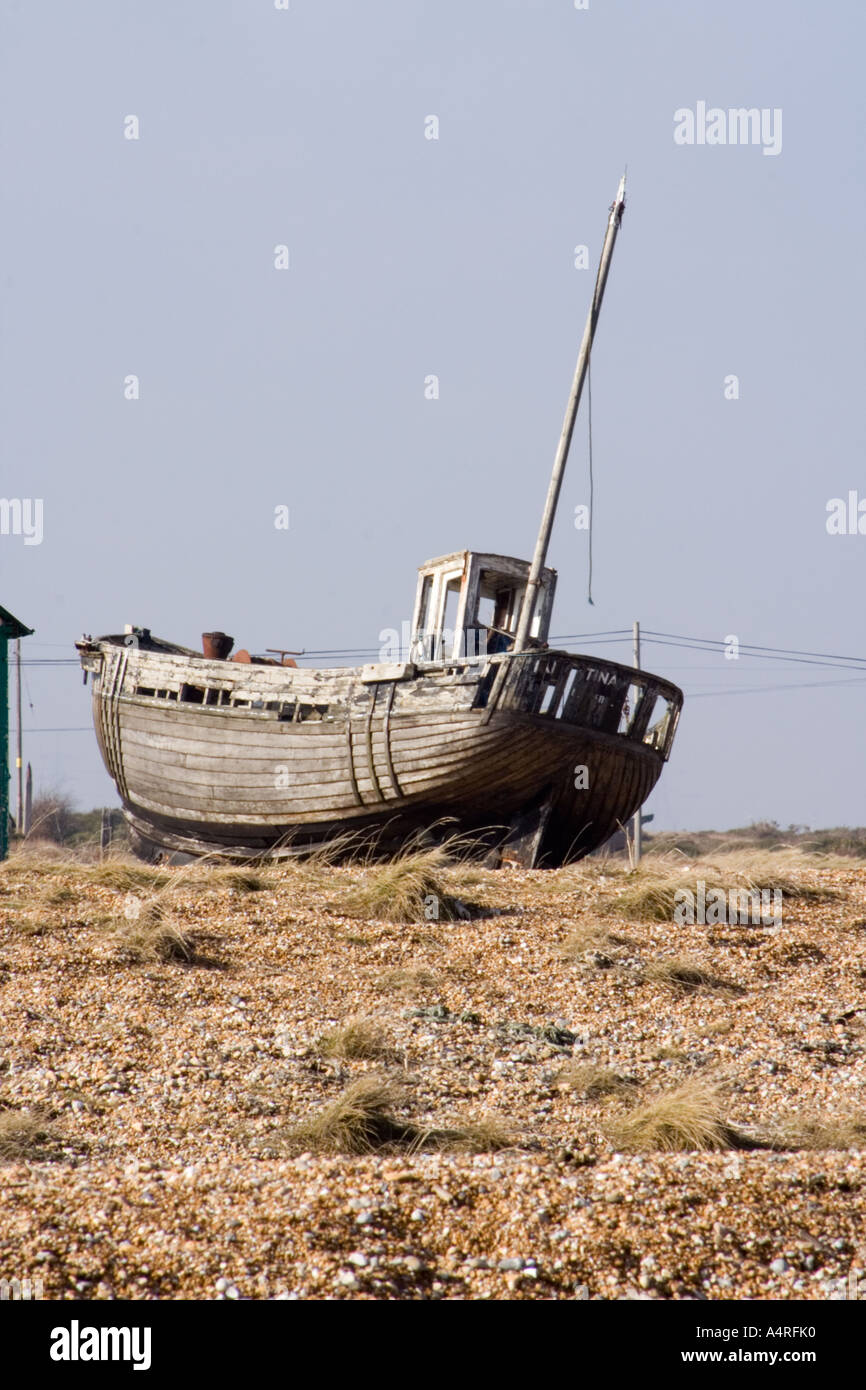 Abandoned wooden fishing boat on the shingle beach at Dungeness in Kent ...