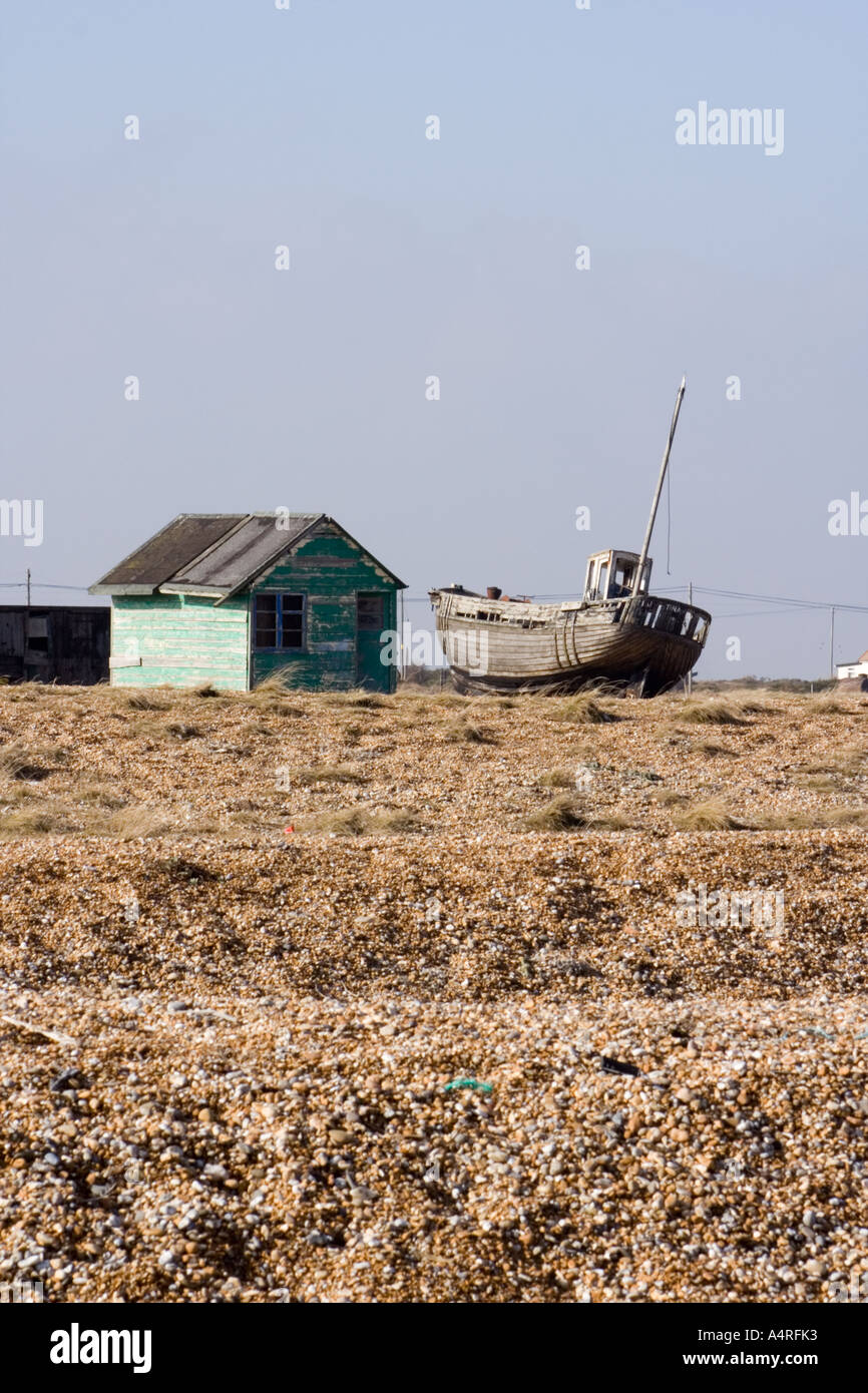 Abandoned wooden fishing boat next to a derelict green hut on the ...