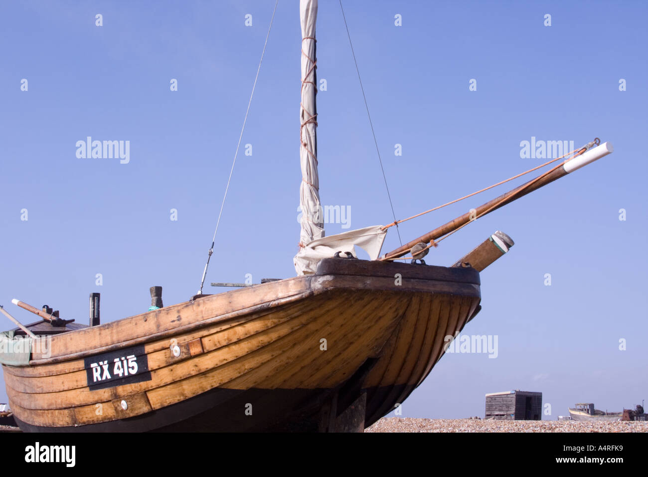 Traditional wooden fishing boat on the shingle beach at Dungeness in ...