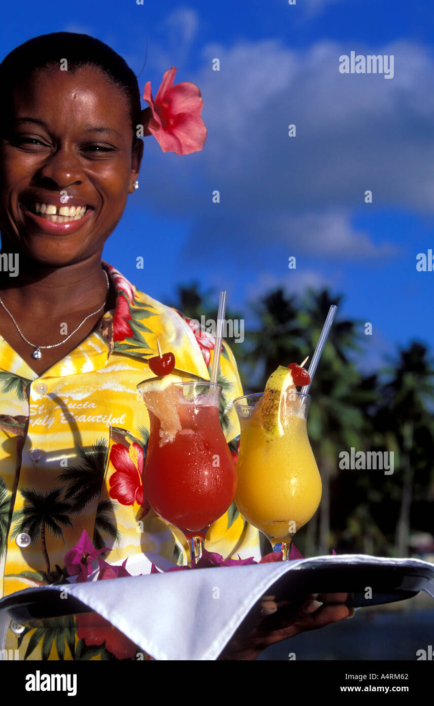 A waitress holding a tray of colorful punch drinks Marigot Bay St Lucia Stock Photo