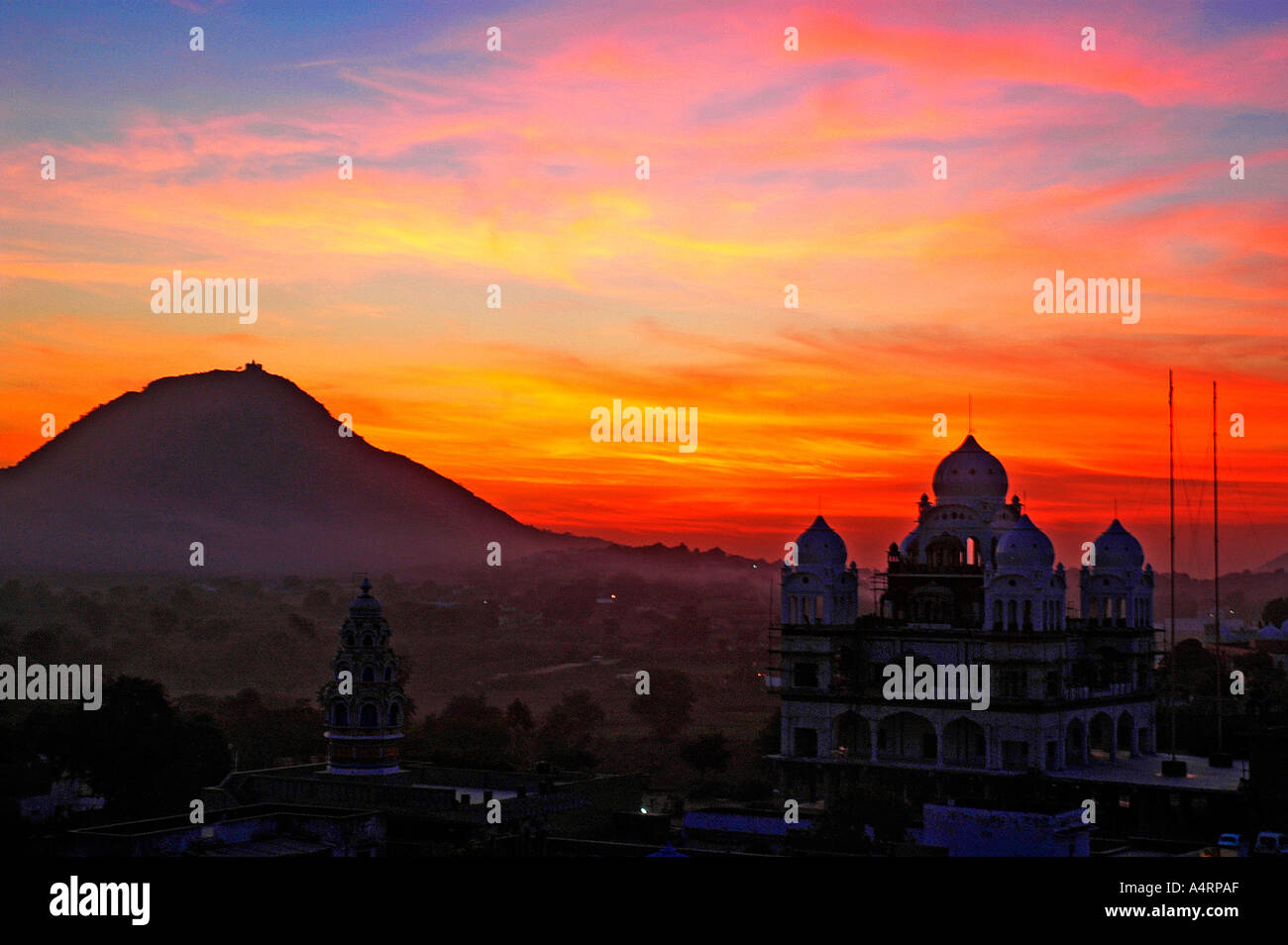 Sub98551 Red Orange Hues Of Sunset Over A Temple And Hill - 