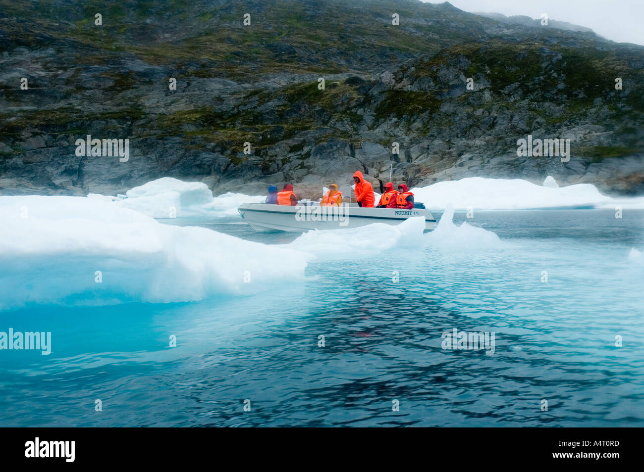 Passengers on an open boat, Angmagssalik Fjord, East Greenland Stock Photo