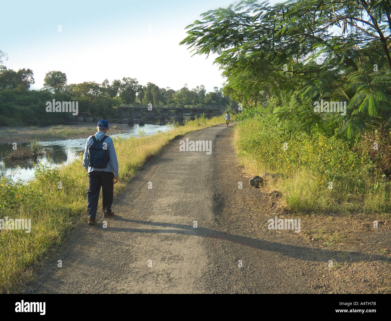 AHP98512 Hiker walking by the river side Kondivade village Karjat Mumbai bombay Maharashtra India Stock Photo
