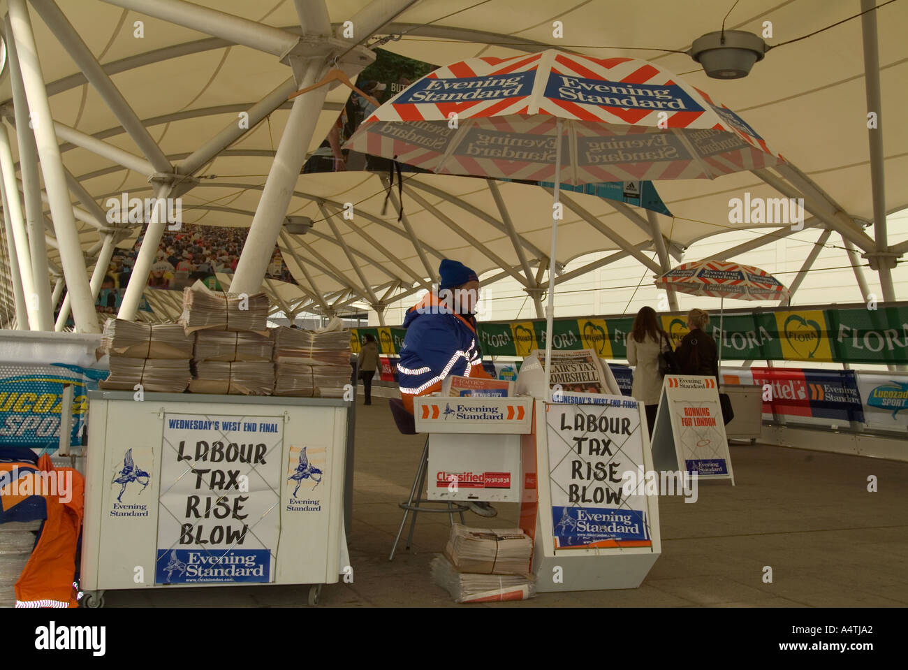 Woman selling Evening Standard daily newspaper for Londoners Docklands London UK Stock Photo