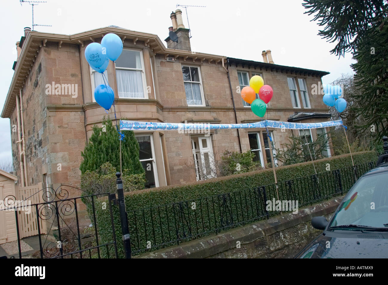 Welcome Home New Baby Balloons And Banner Outside House In Glasgow