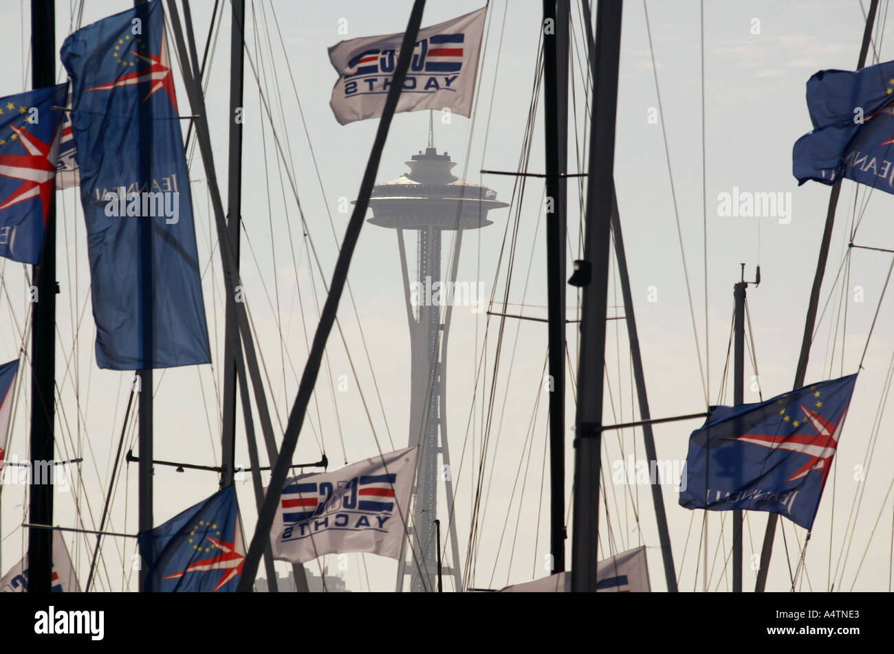 Space Needle in Seattle seen through sail boat flags and rigging along