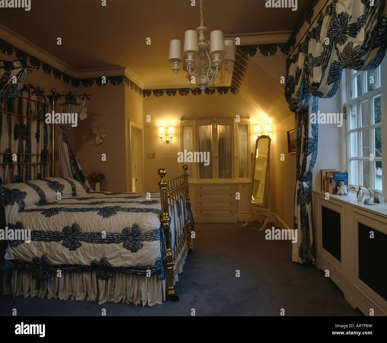 Traditional Bedroom With Wall Lights And Blue And White Bedlinen