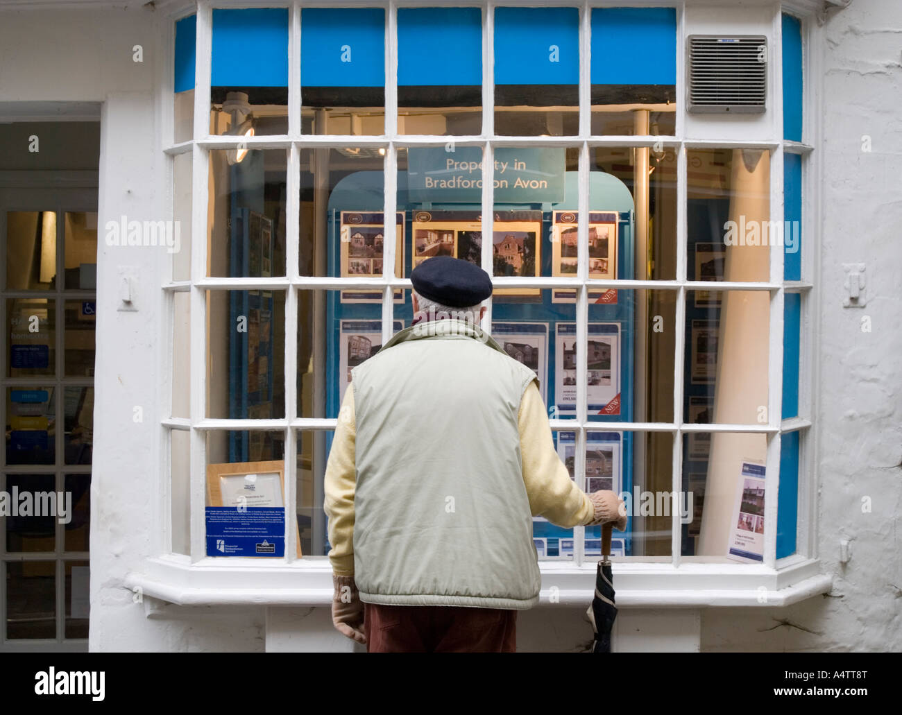 Bradford on Avon Wiltshire UK A man looks into an estate agency window Stock Photo