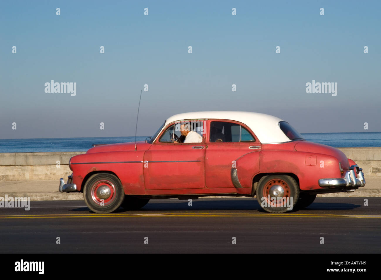 Taxi ride in a classic American car driving along El Malecon, Havana, Cuba Stock Photo