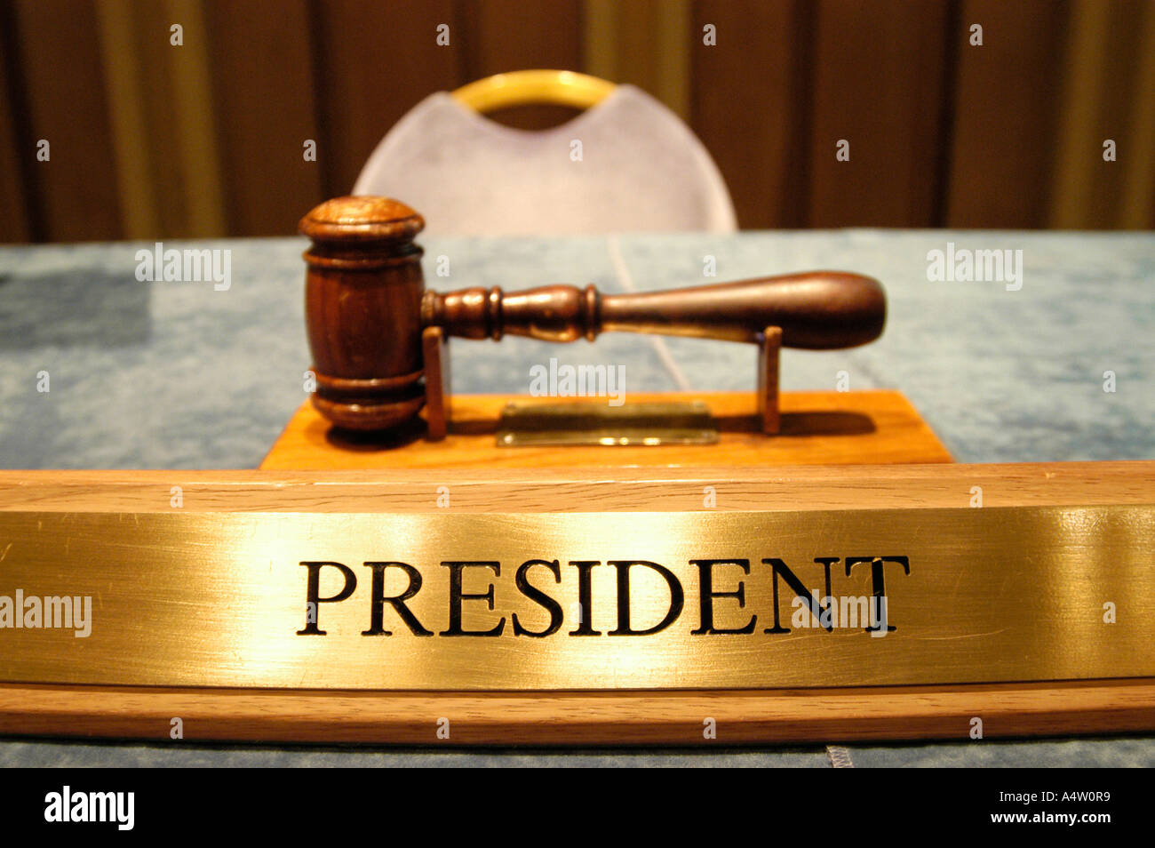 President title plate and empty seat at company boardroom, England