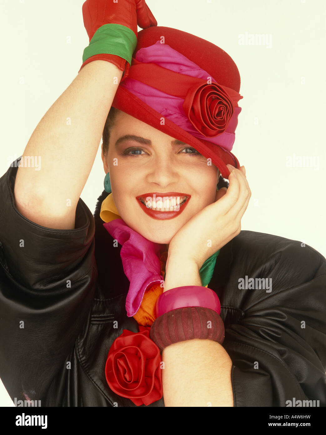 GIRL IN RED HAT GLOVES RED ROSE DETAIL Stock Photo
