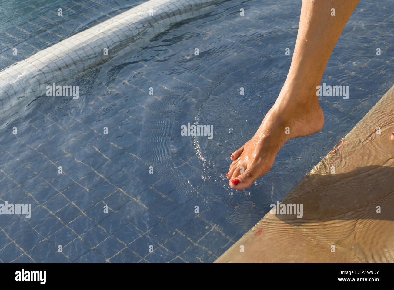 Woman dipping toe swimming pool hires stock photography and images Alamy