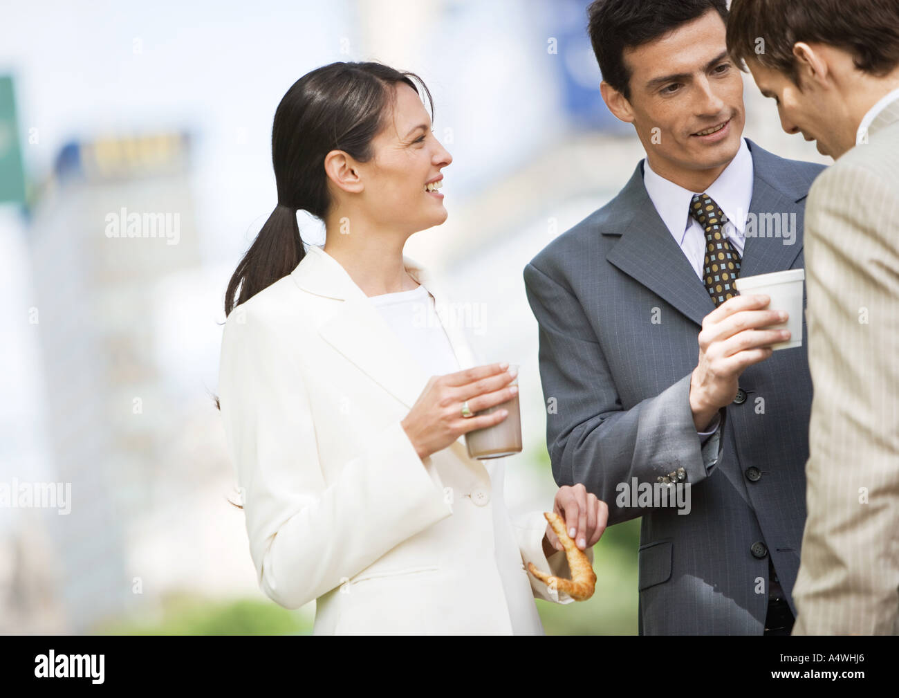 Business colleagues having coffee outdoors Stock Photo