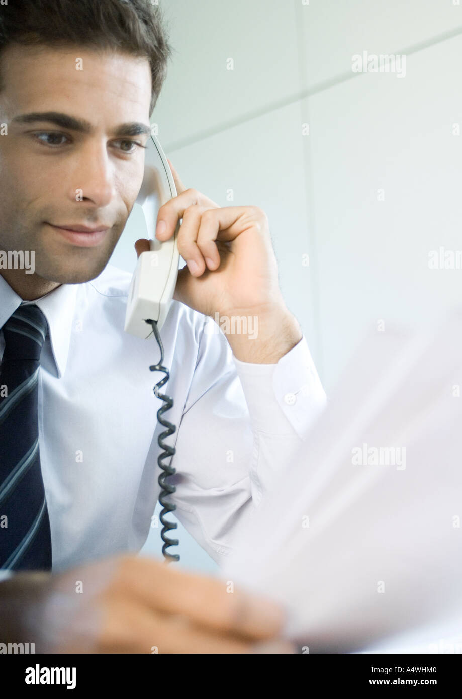 Businessman using landline phone Stock Photo - Alamy