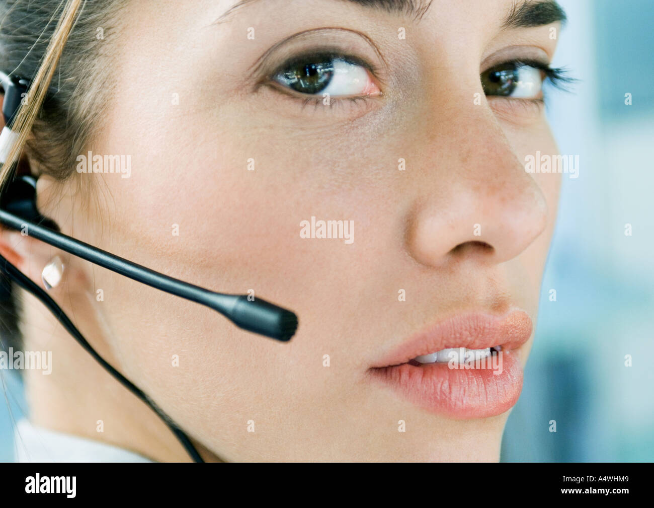 Woman wearing headset, close-up Stock Photo