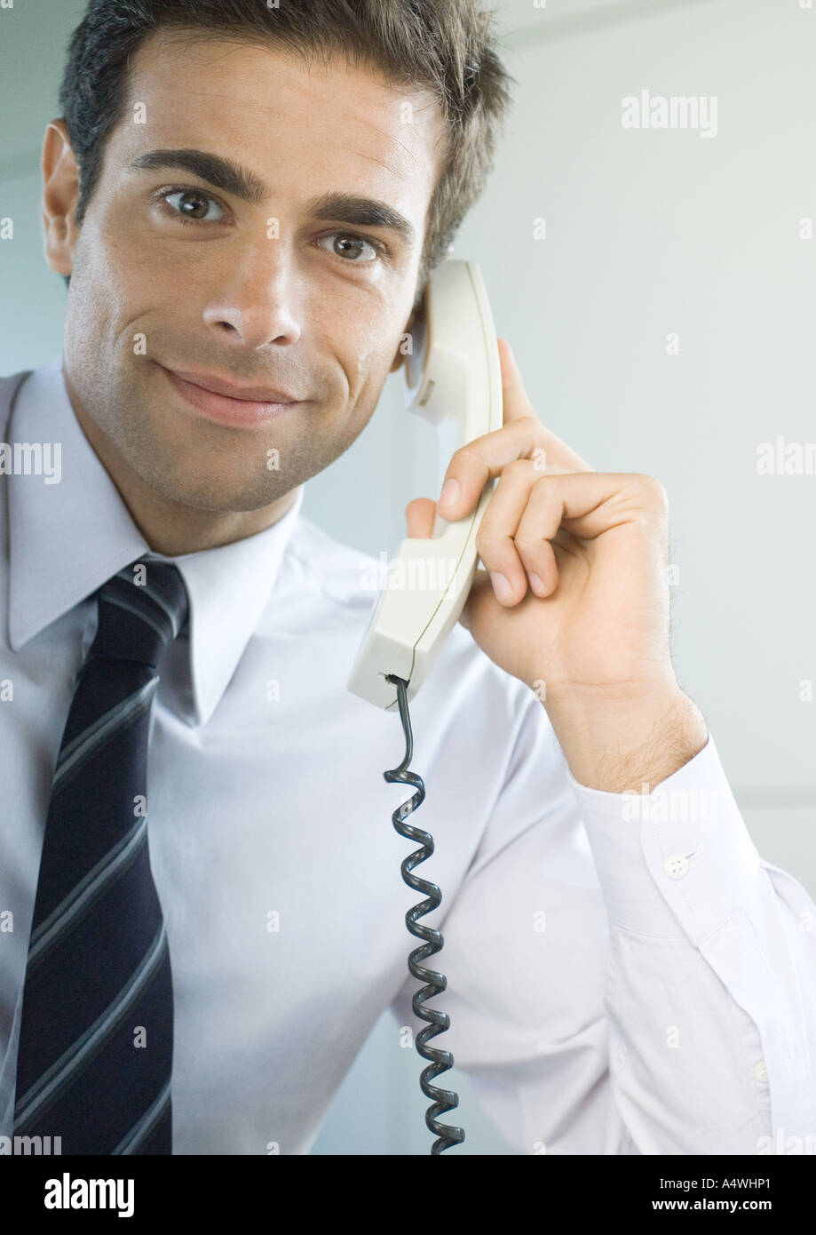 Businessman using landline phone Stock Photo - Alamy