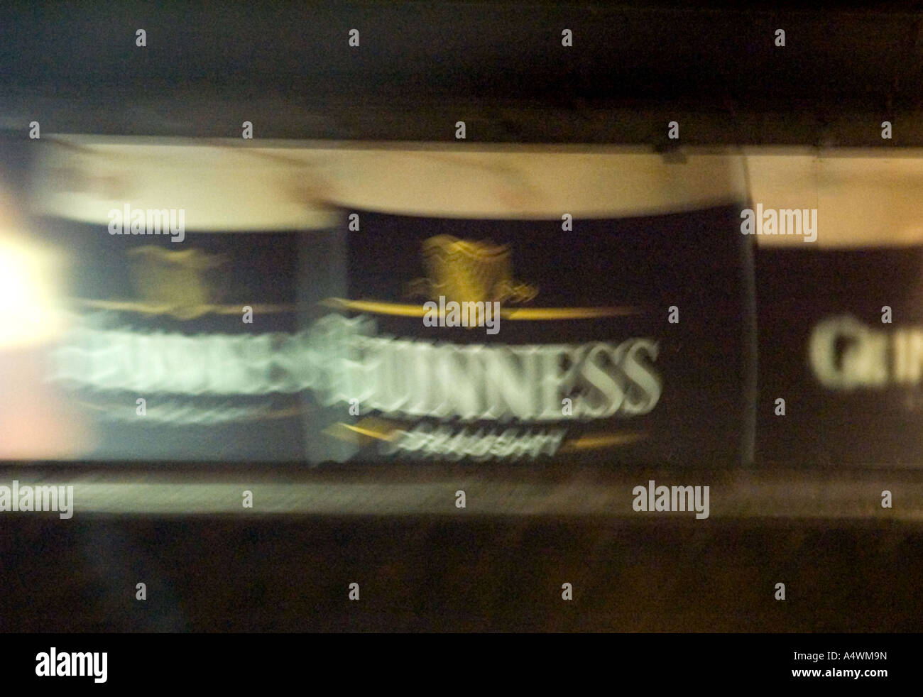 motion shot of a billboard displaying Guiness in Dublin Ireland Stock Photo