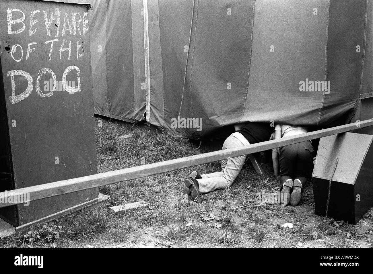 Beware of the dog sign. Derby Day Fair. Epsom Downs, Surrey  England 1971 1970s UK HOMER SYKES Stock Photo