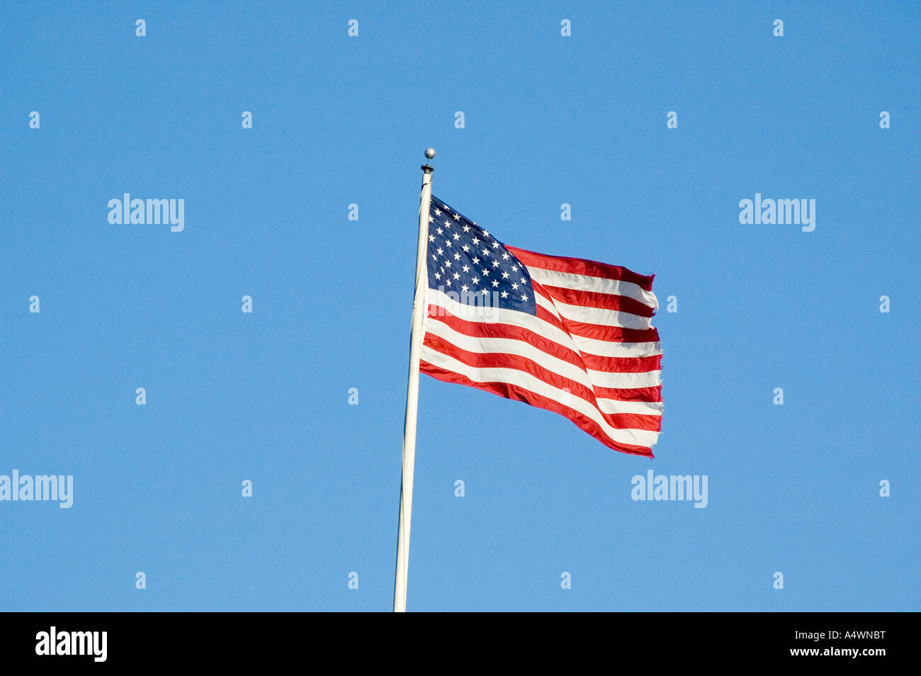 American flag set against a blue sky Stock Photo - Alamy