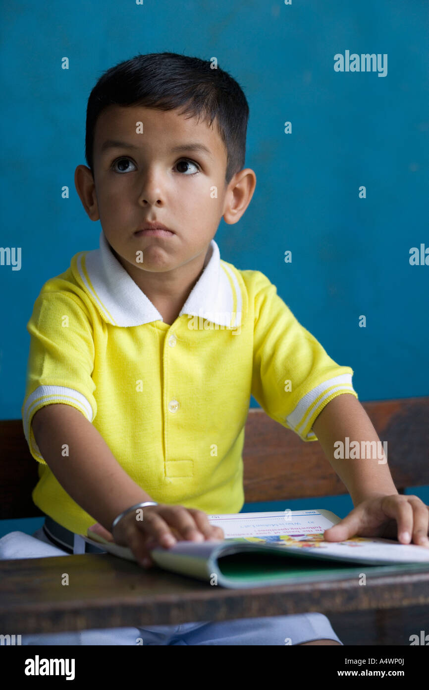 Young boy sitting at desk Stock Photo Alamy
