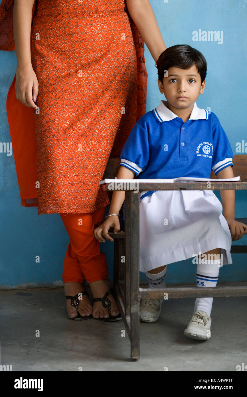 Teacher standing behind student Stock Photo Alamy