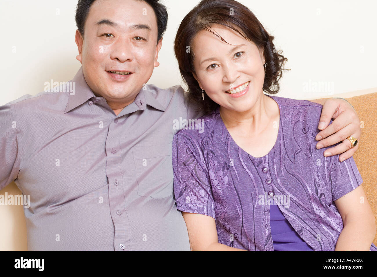 Middle aged asian couple hugging and smiling hi-res stock photography ...