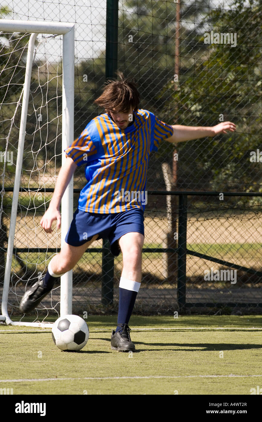 Soccer player kicking the ball Stock Photo Alamy