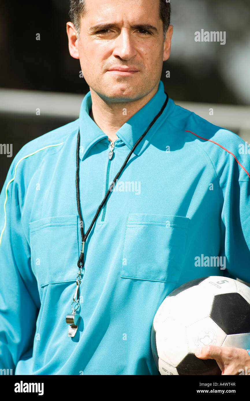 referee holding a soccer ball Stock Photo