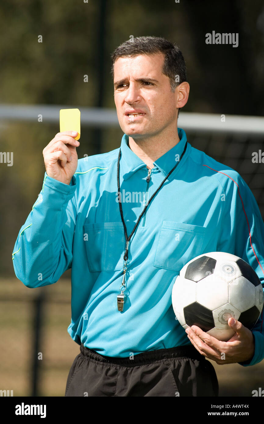 referee holding a yellow card Stock Photo