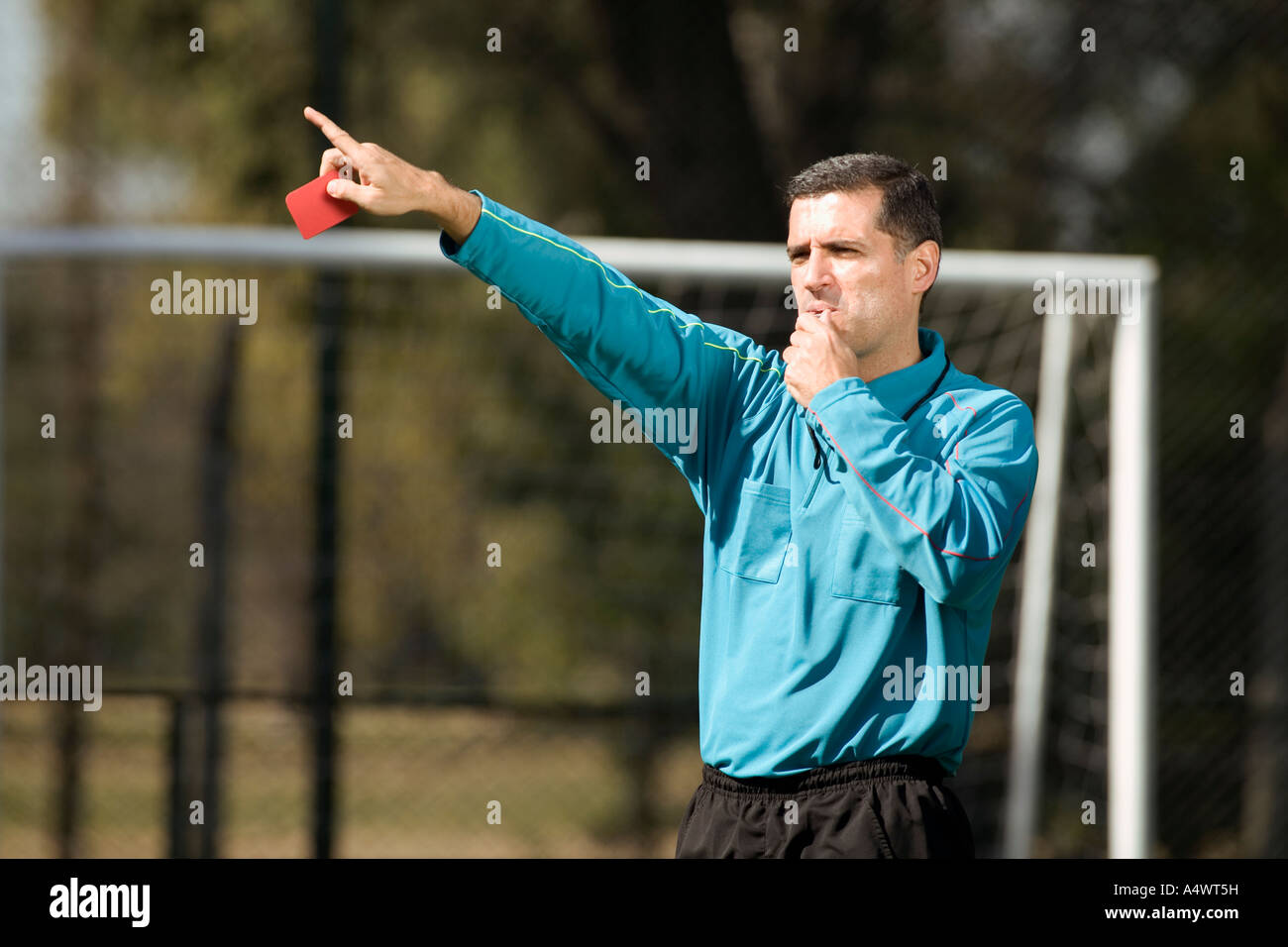 referee showing a soccer player the red card Stock Photo