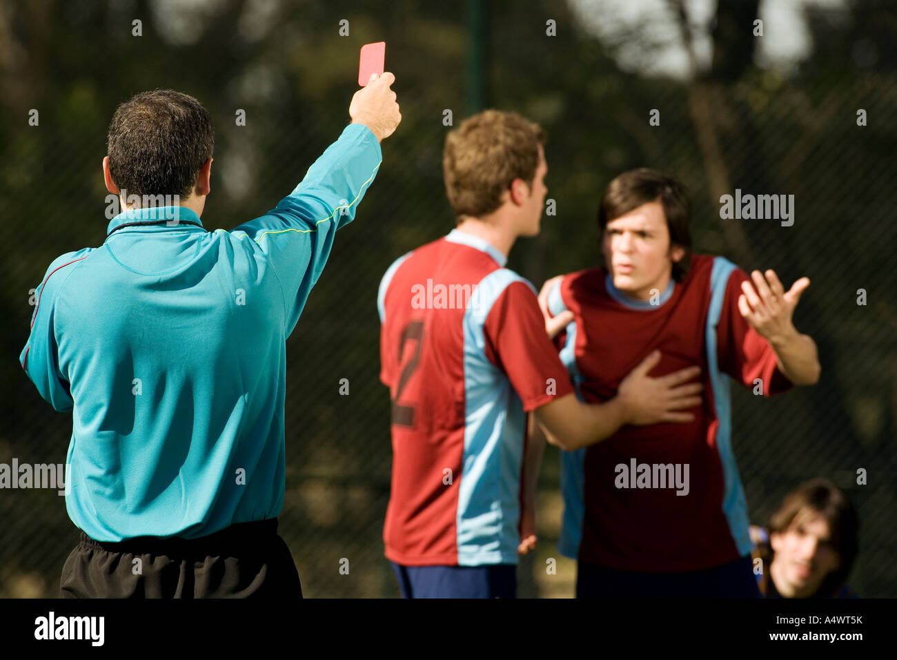 Soccer referee showing players the red card Stock Photo