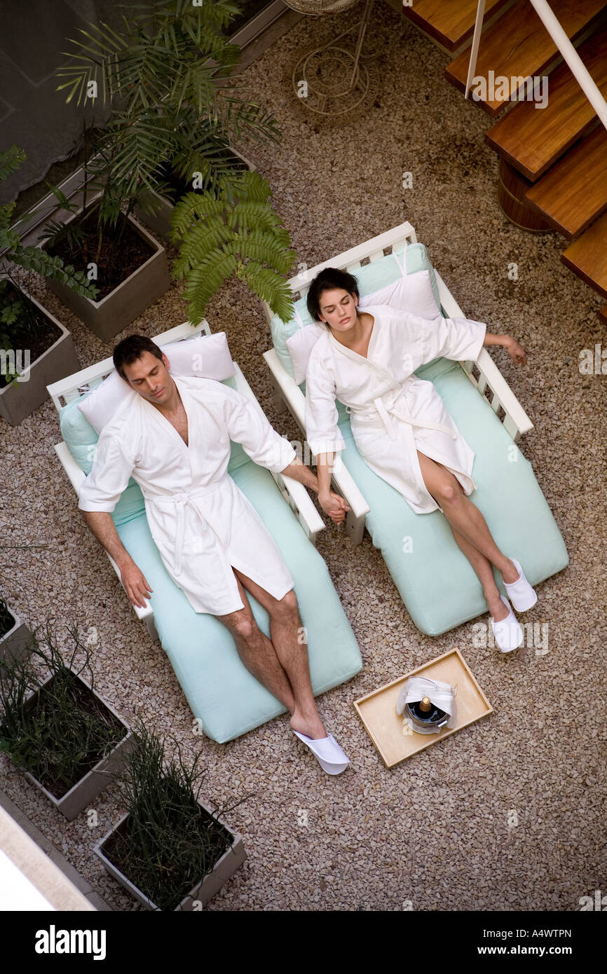 Couple relaxing in bathrobes in lawn chairs Stock Photo - Alamy