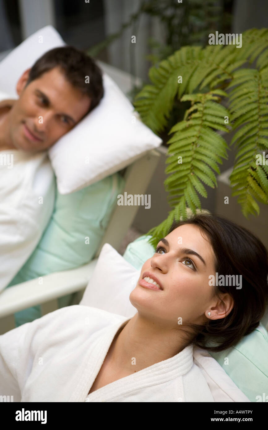 Couple relaxing in bathrobes in lawn chairs Stock Photo - Alamy