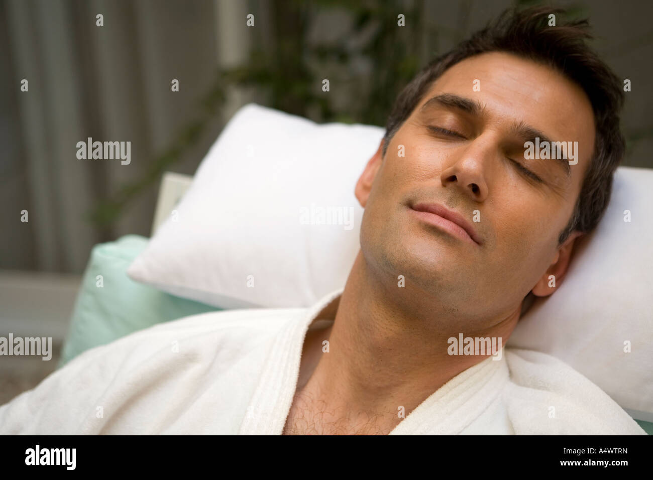Man sleeping in bathrobe Stock Photo Alamy