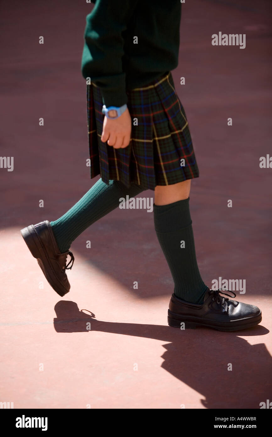 Student walking on pavement Stock Photo - Alamy