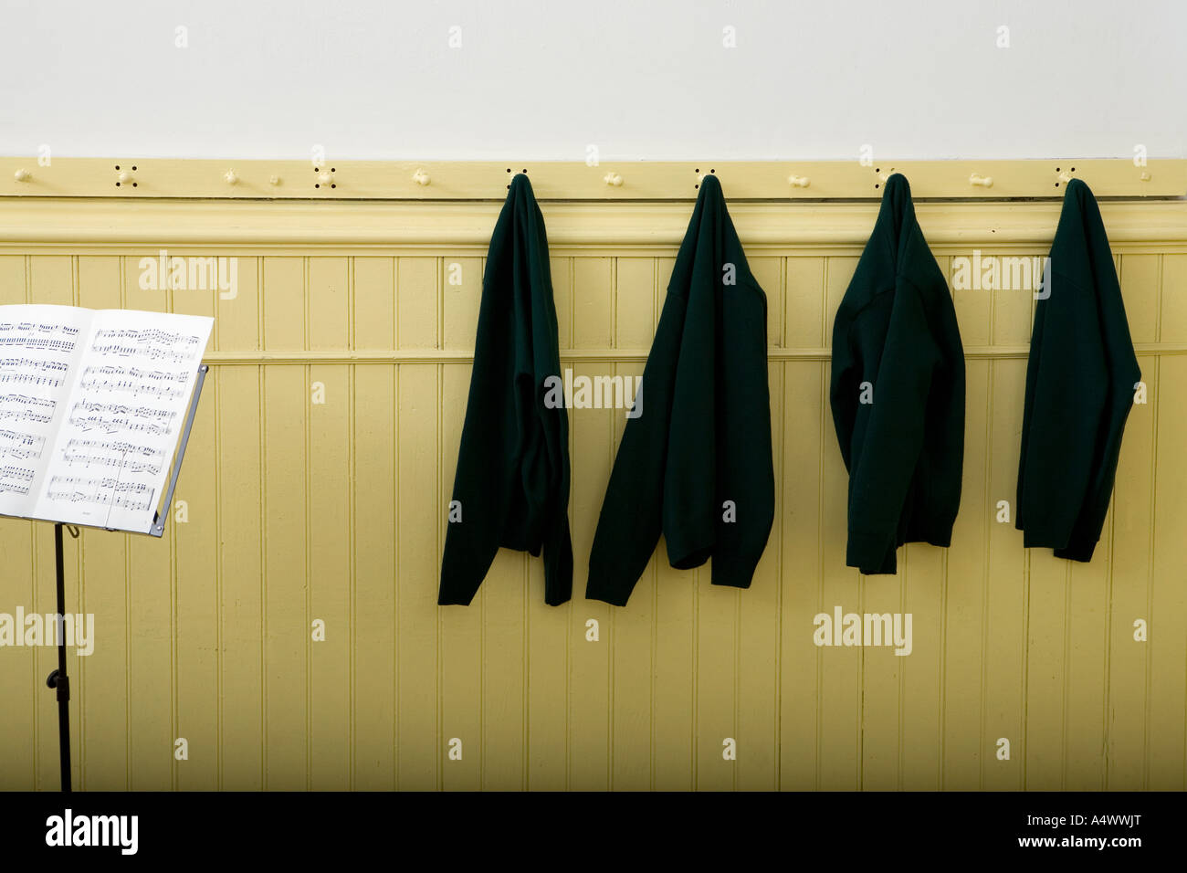 Uniform sweaters hanging on hooks hires stock photography and images