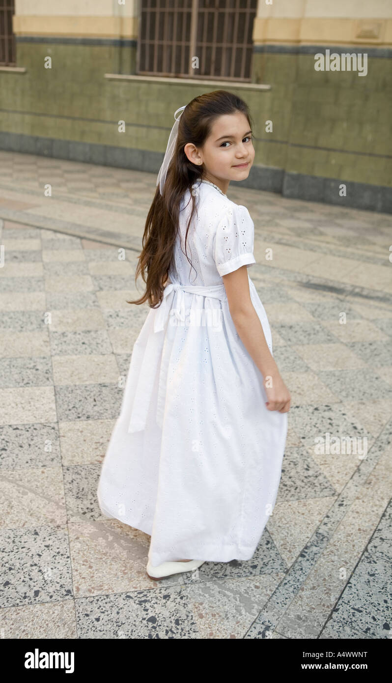 Young girl wearing white gown in courtyard Stock Photo Alamy