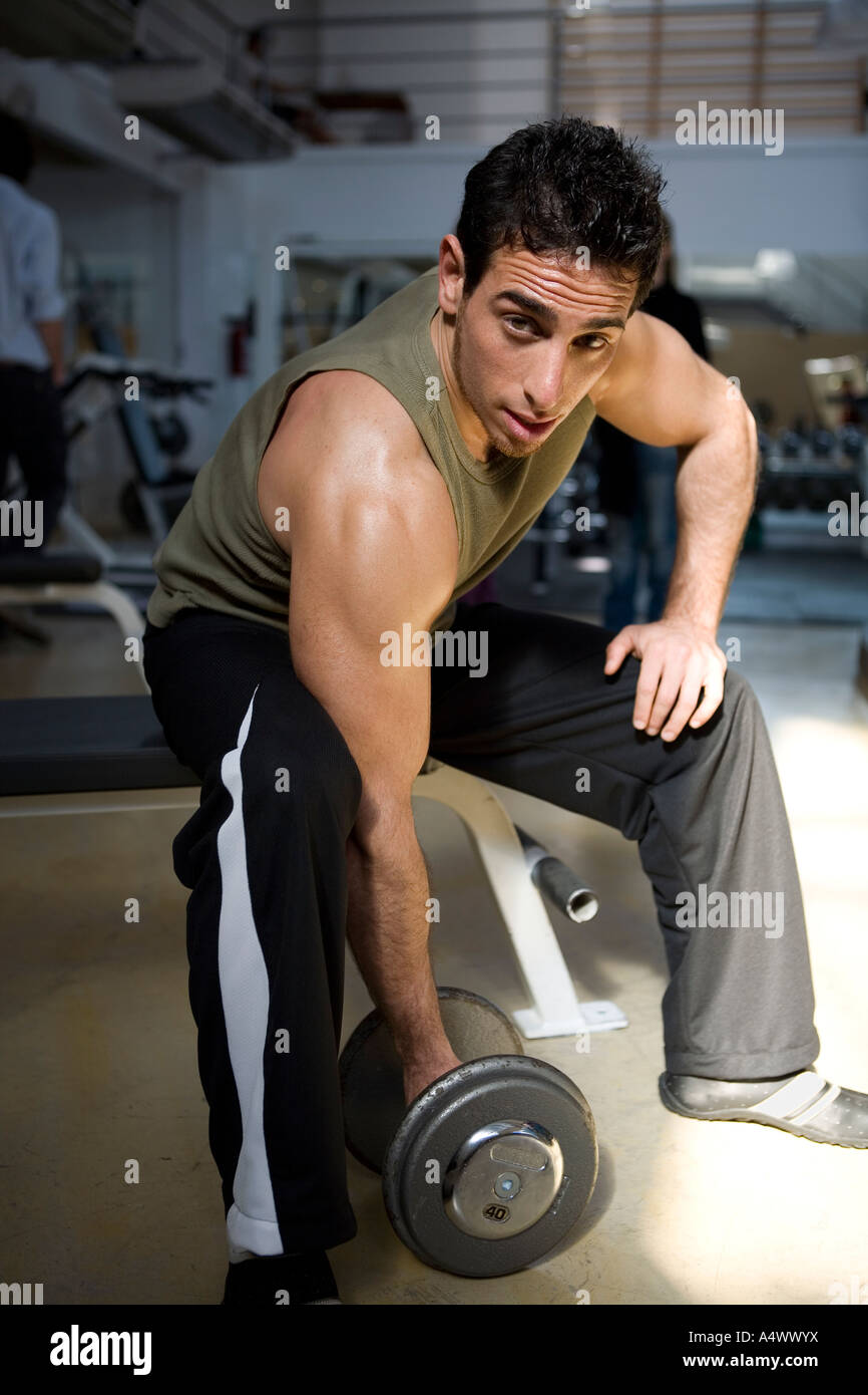 Man lifting weights at a gym Stock Photo