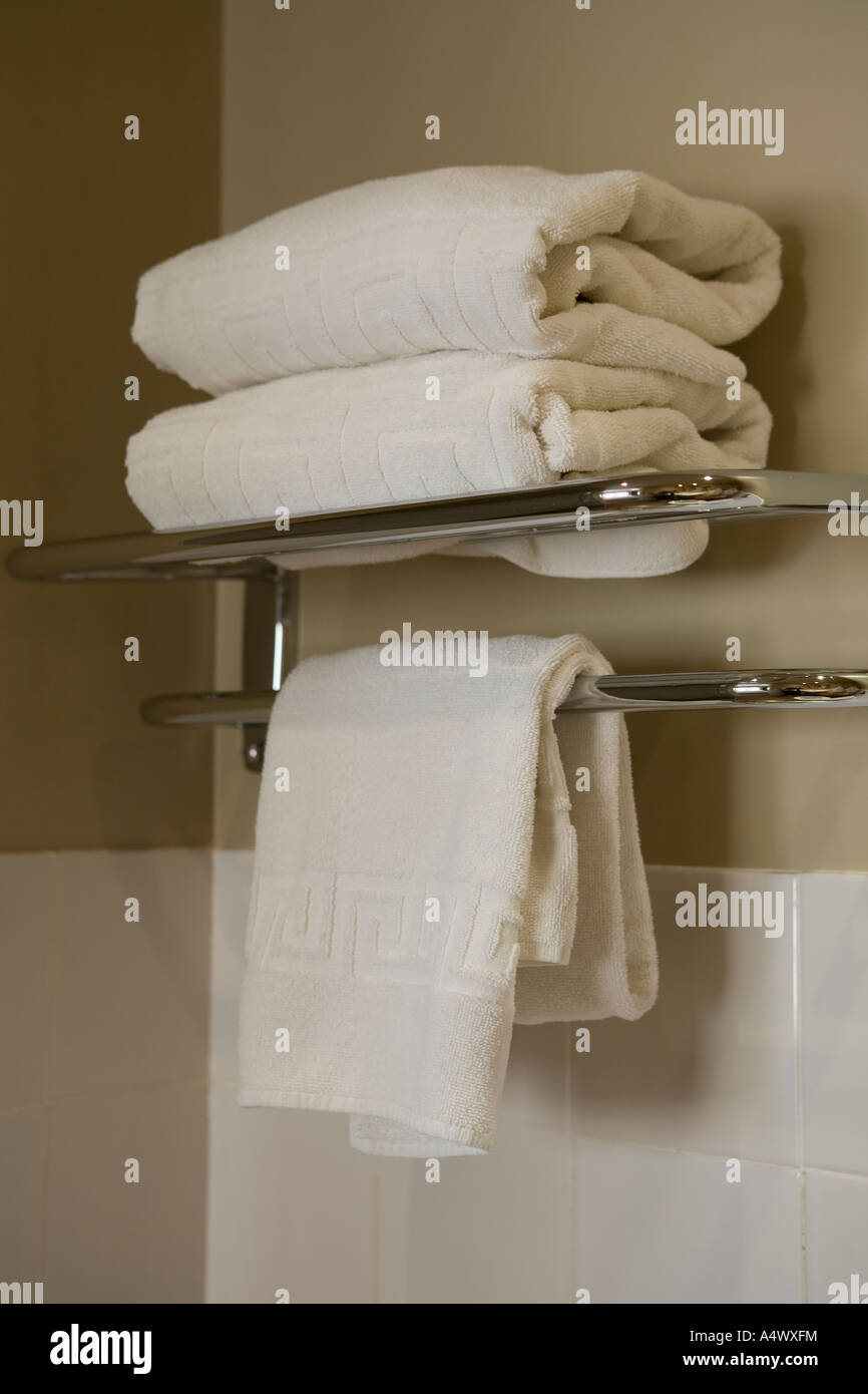 Towels folded on bathroom shelf Stock Photo - Alamy