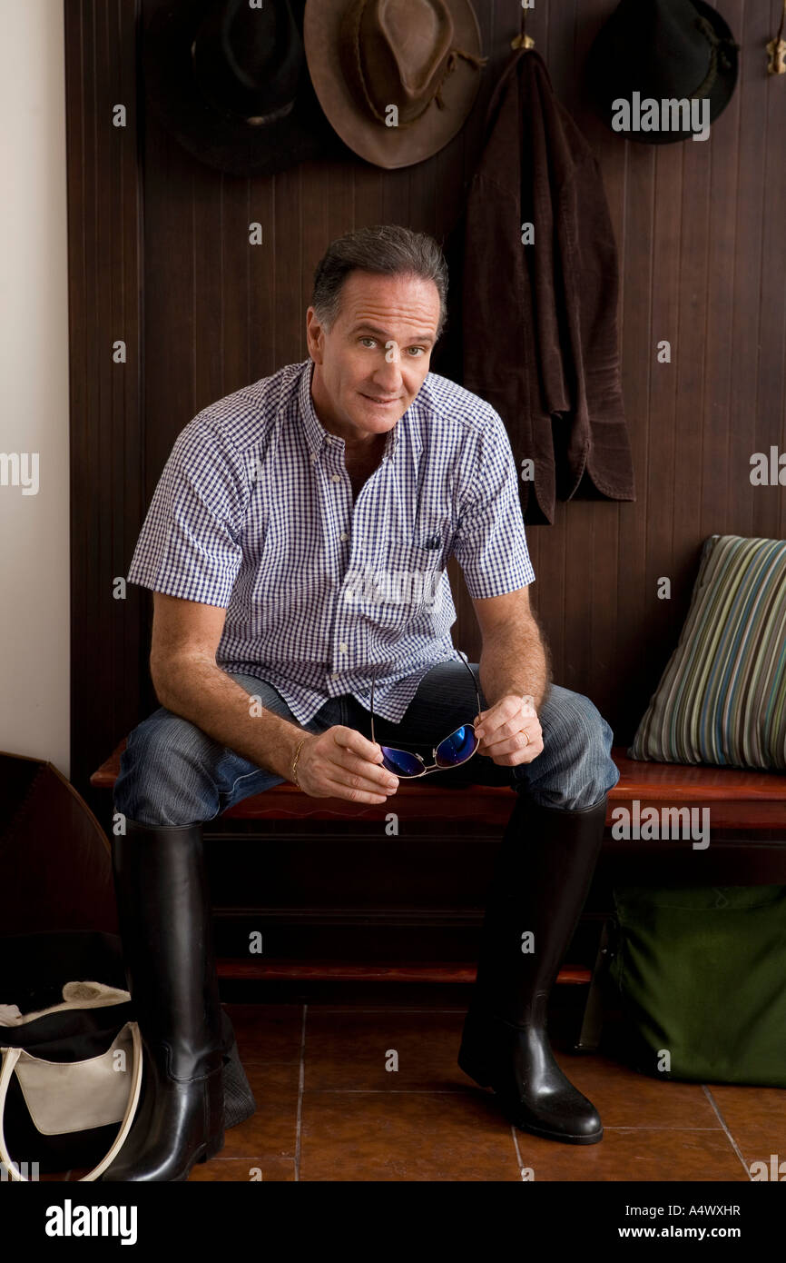 Man wearing riding boots indoors Stock Photo Alamy