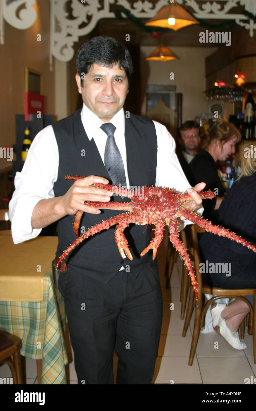 Waiter holding a king crab in a fish restarant in Ushuaia,Argentina