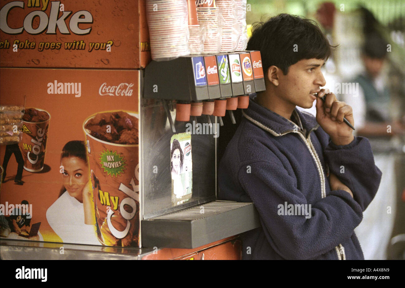 Salesboy next to a Coke vending machine Saket South Delhi Ne Stock