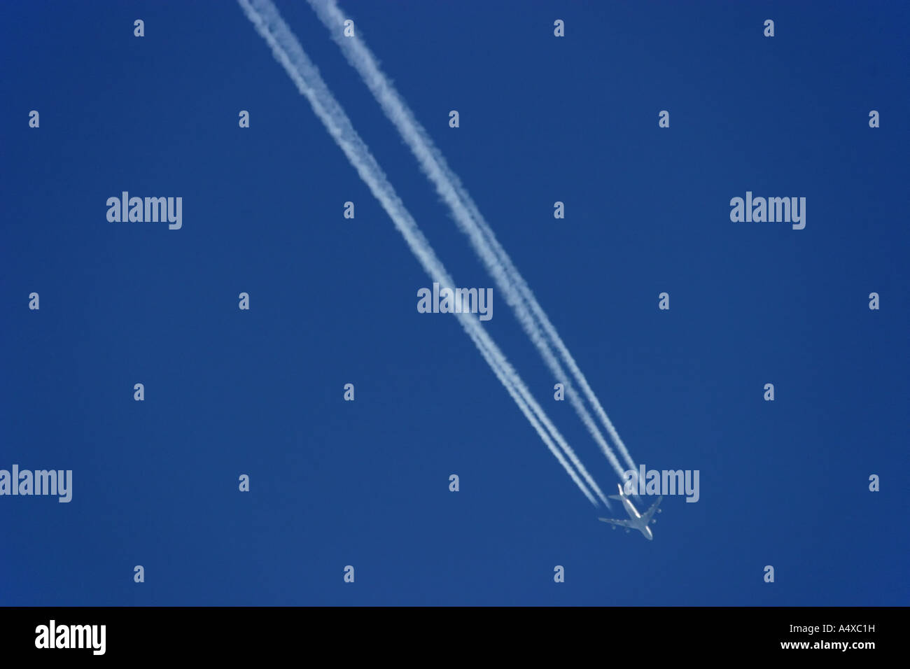 Is aviation declining? Jet with vapor trail, emission of carbon dioxide Stock Photo