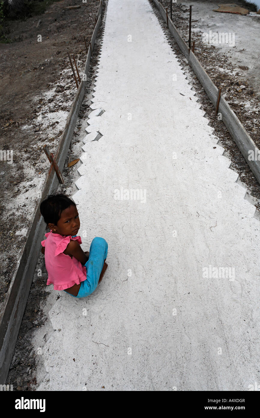 Child on footpath in Tanjung Harapan village, Central-Kalimantan, Borneo, Indonesia Stock Photo