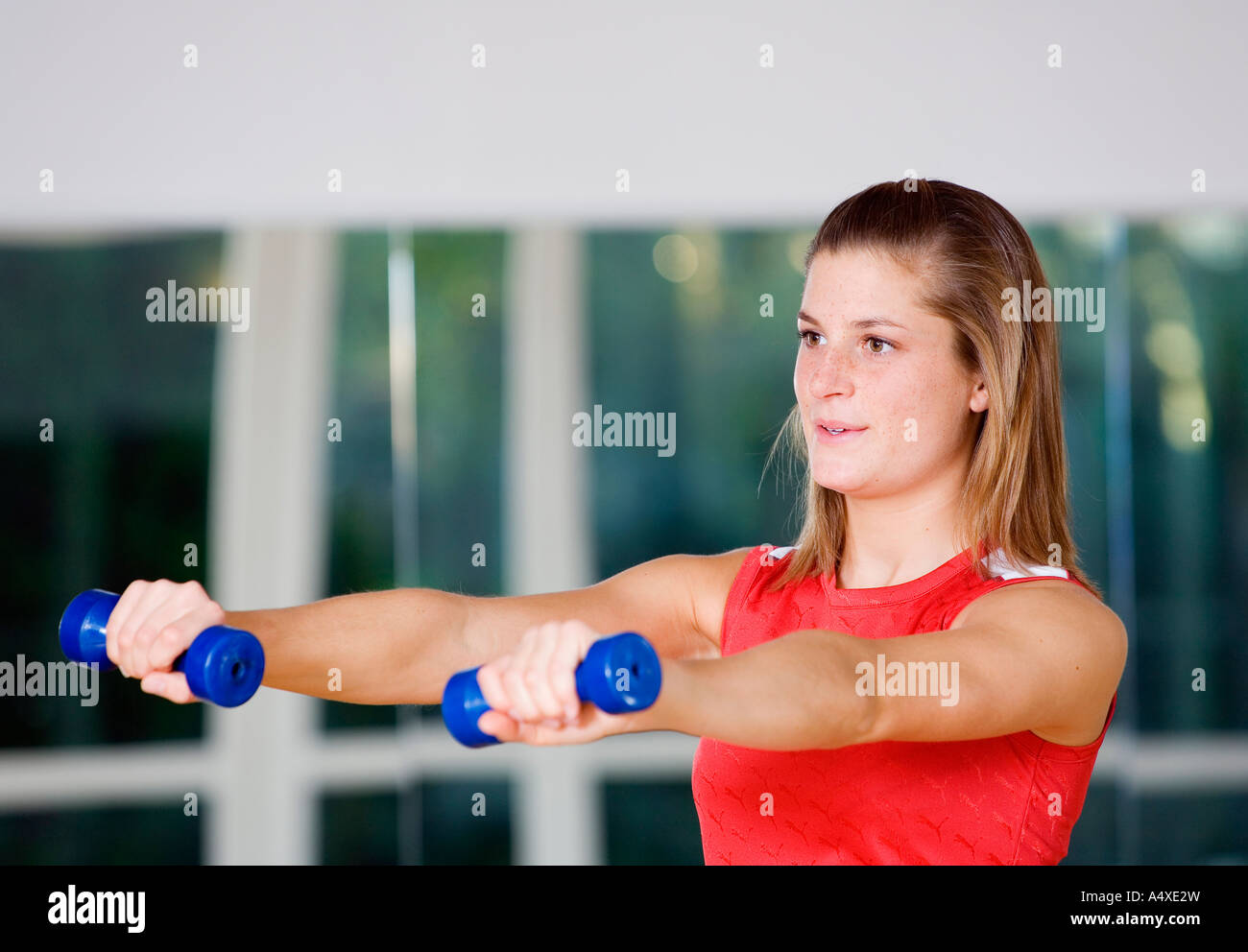 A young woman with two dumb bells Stock Photo