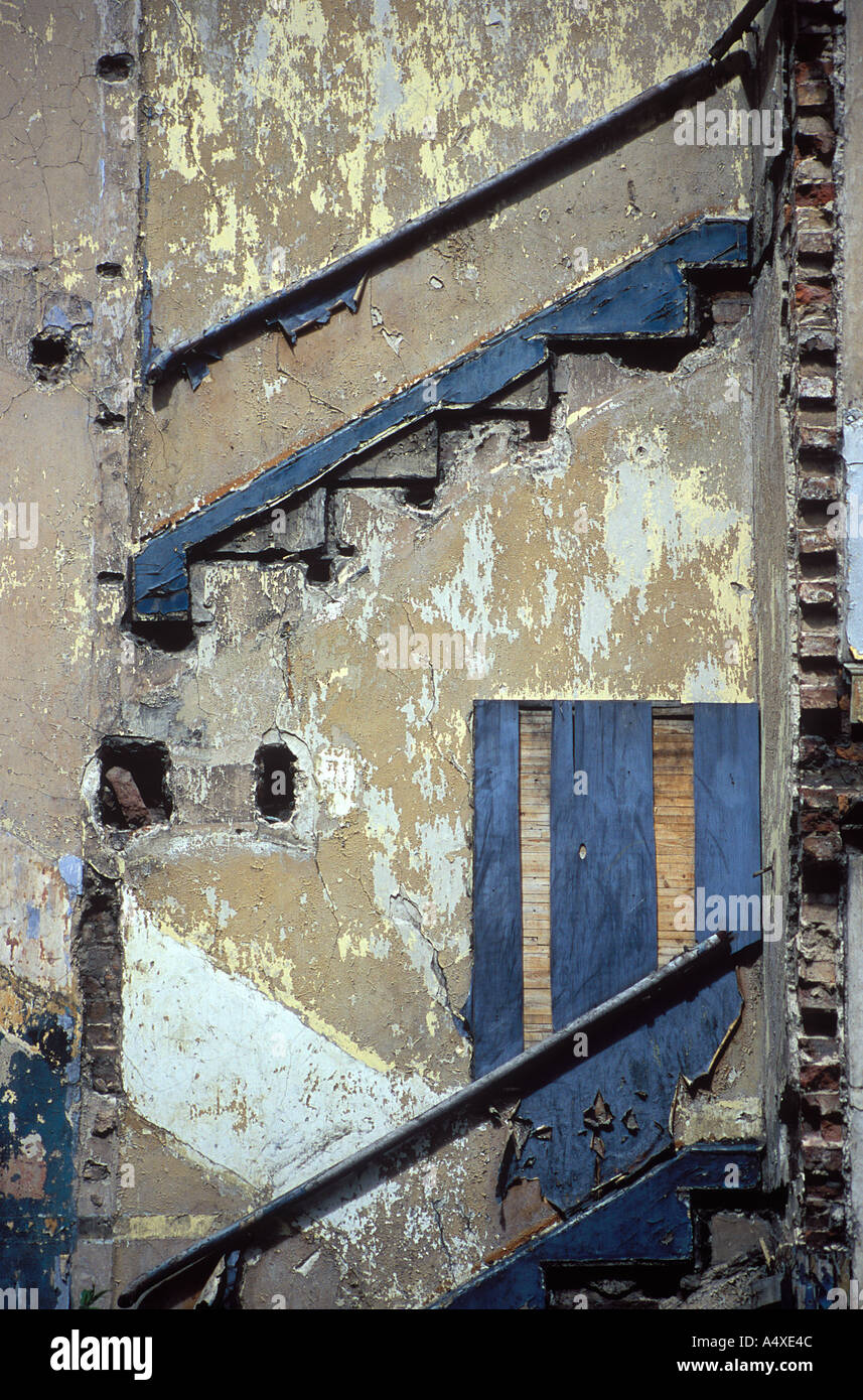 The abstract lines of ghostly steps rise in the derelict wall of a condemned house Stock Photo