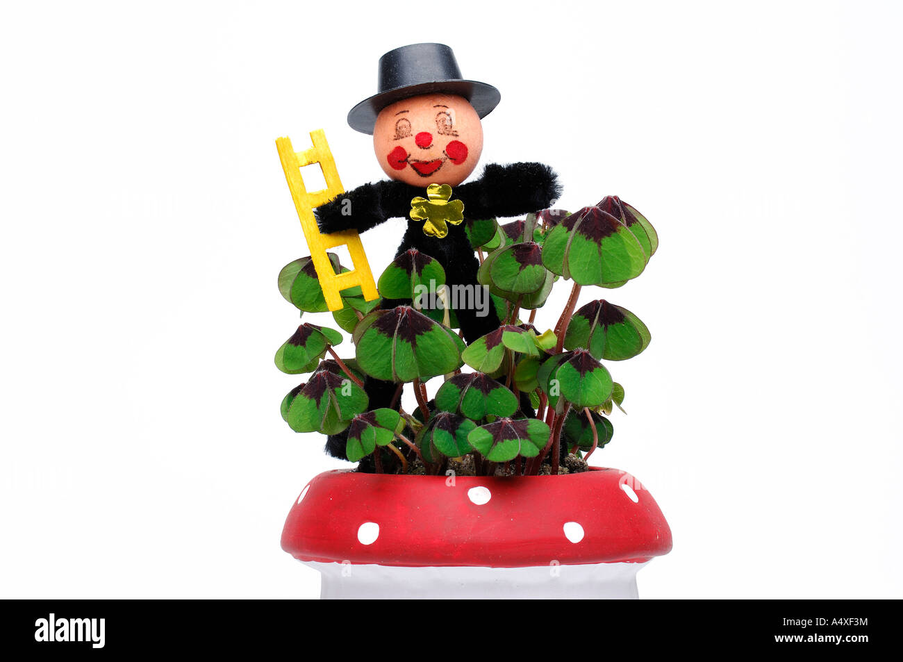 Chimney sweep as a good luck charm with clovers in a flower pot Stock Photo