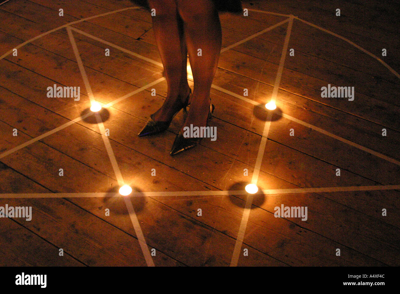 girl standing in a pentagram Stock Photo