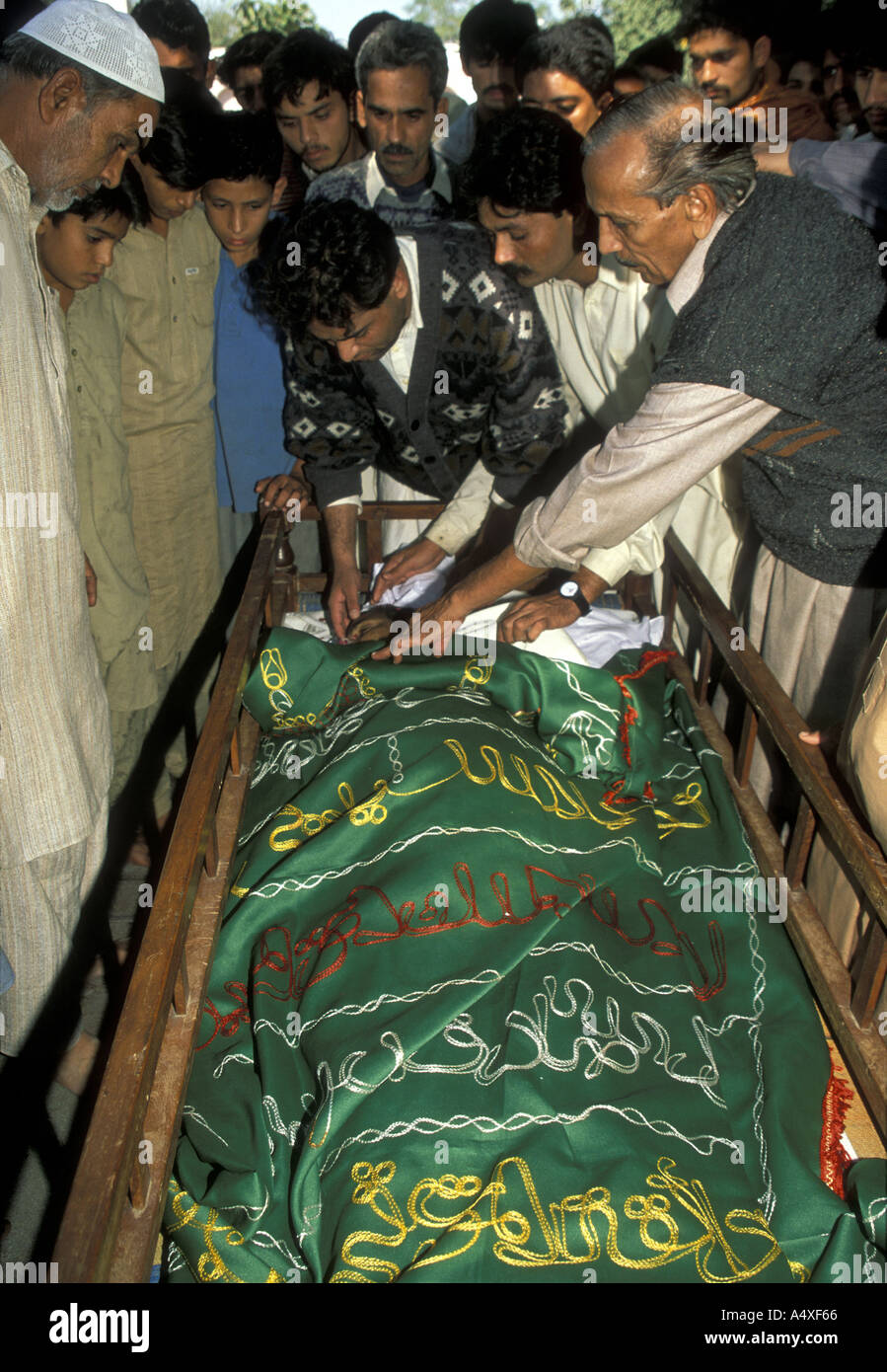Sons farewell  their father at a Muslim funeral in Pakistan Stock Photo