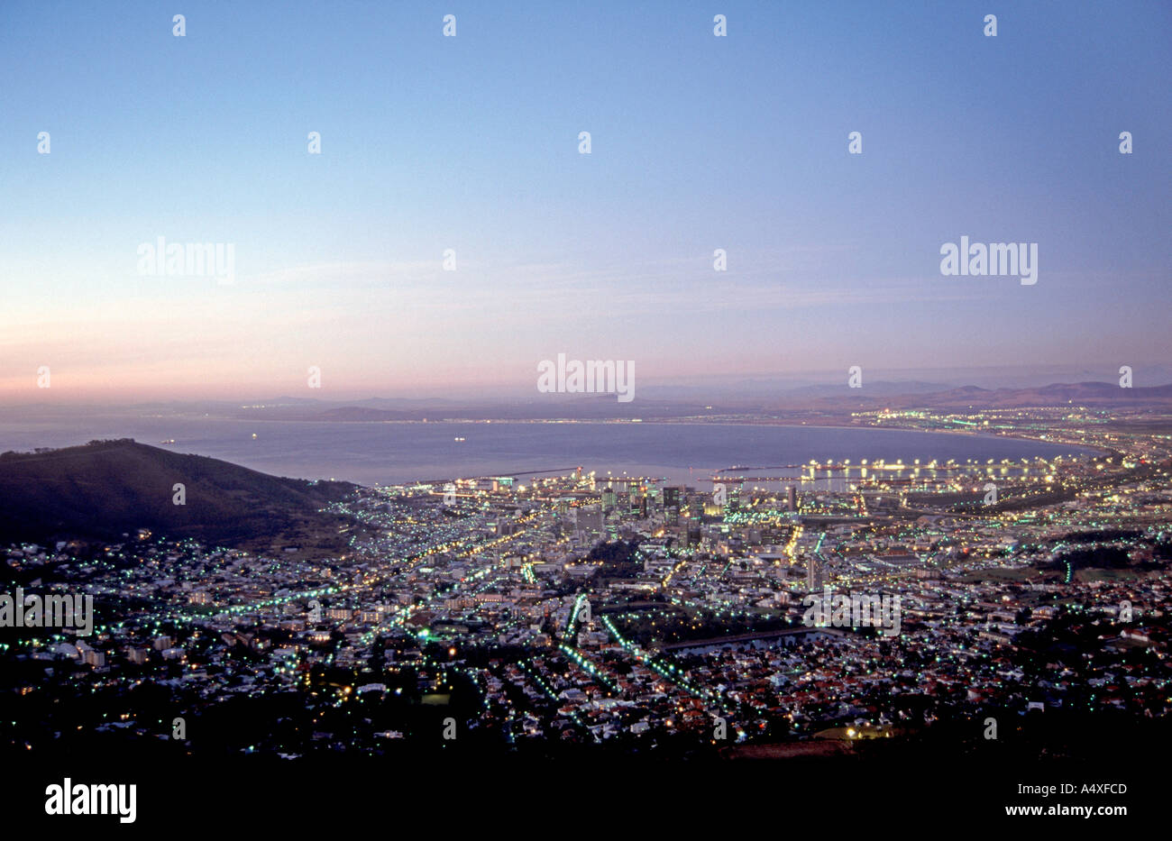 The city of Cape Town at dusk with Table Bay and Signal Hill visible. Stock Photo